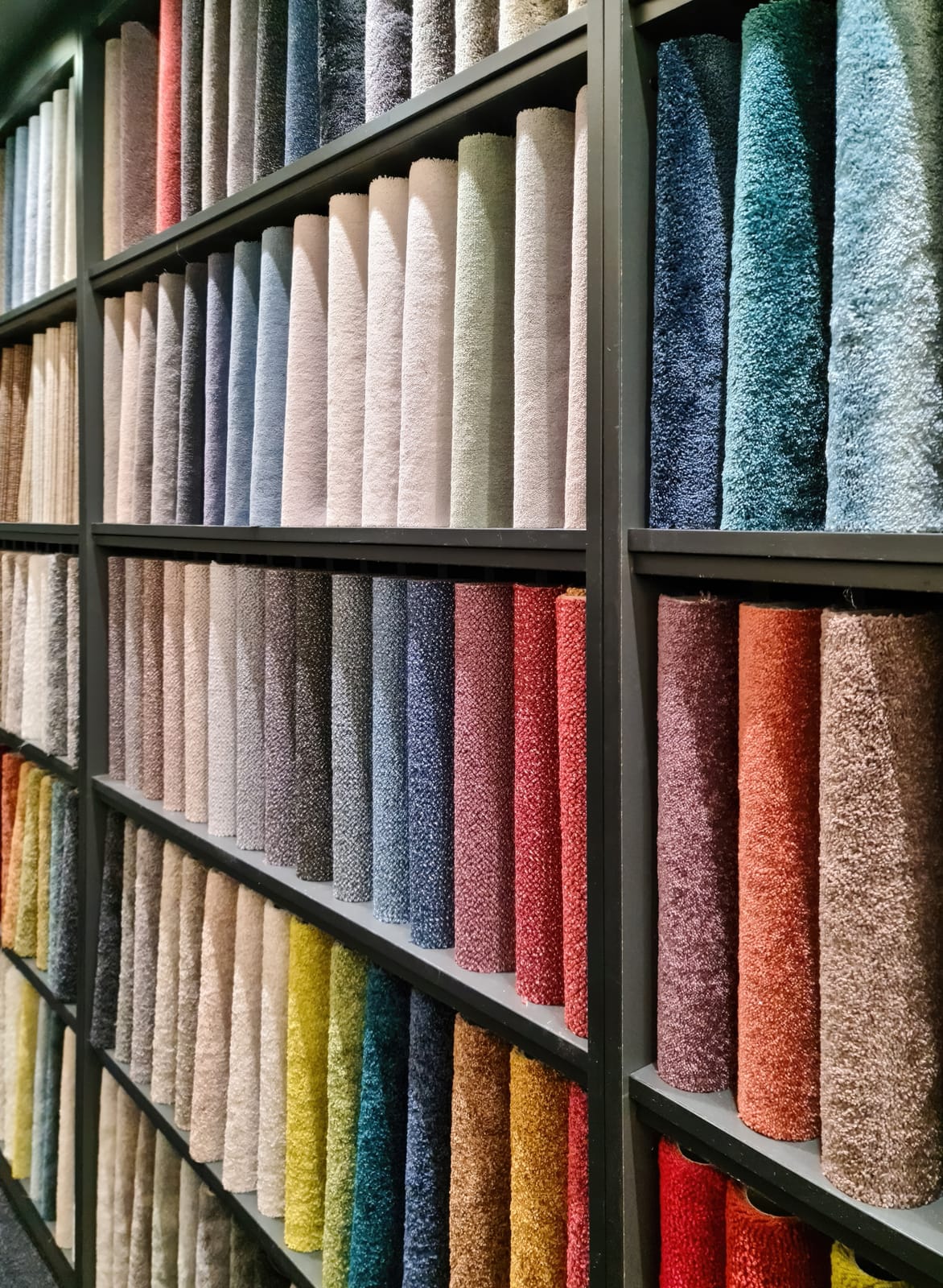 A shelf with rugs selection.